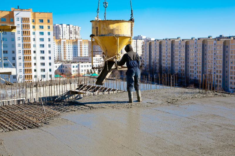 Cement-mixers-worker-pouring-concrete-min