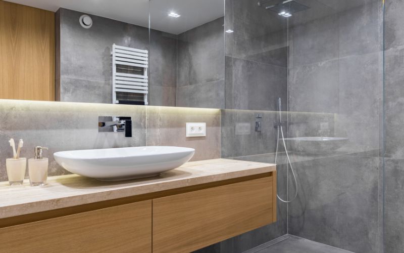 concrete-mixers-gray-bathroom-with-long-countertop-min