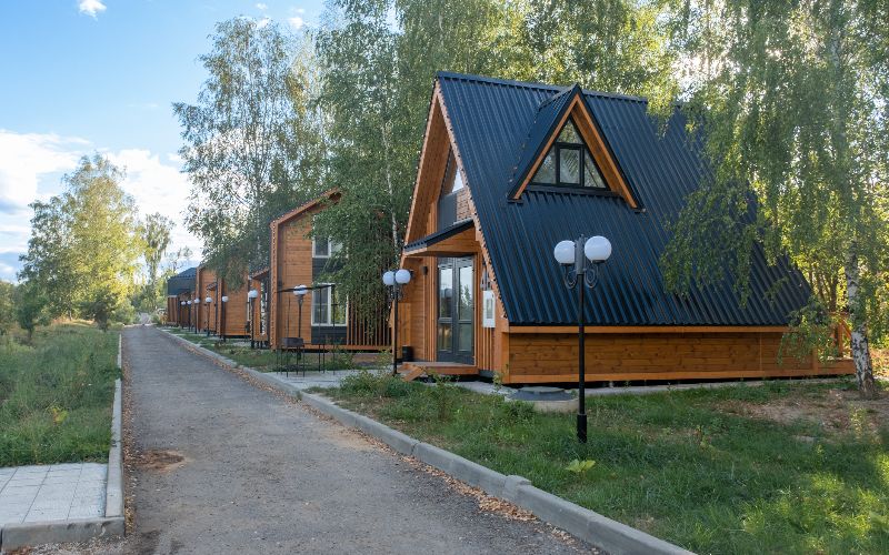 Concrete-mixer-a-group-of-barn-style-houses-modern-stylish-houses-in-the-sun-blue-sky-min