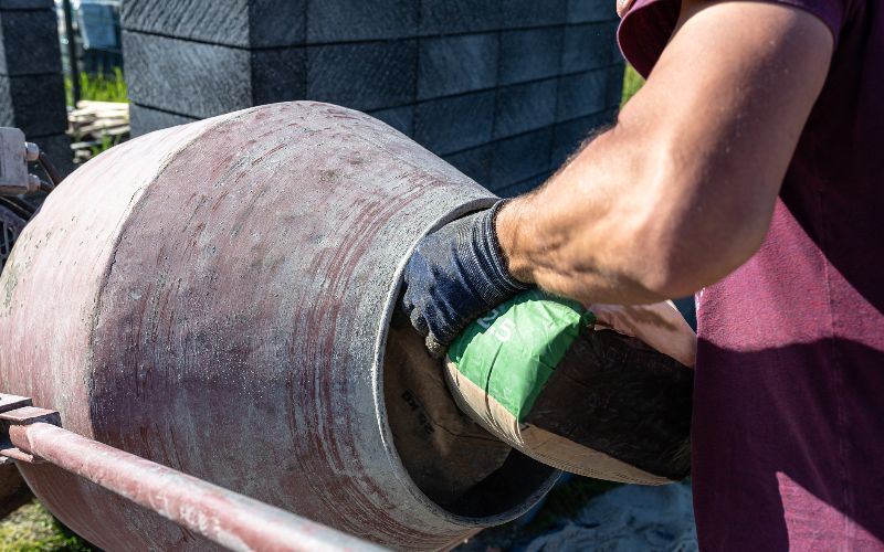 cement-mixers-mixing-different-ingredients-for-concrete-in-a-portable-concrete-mixer-min