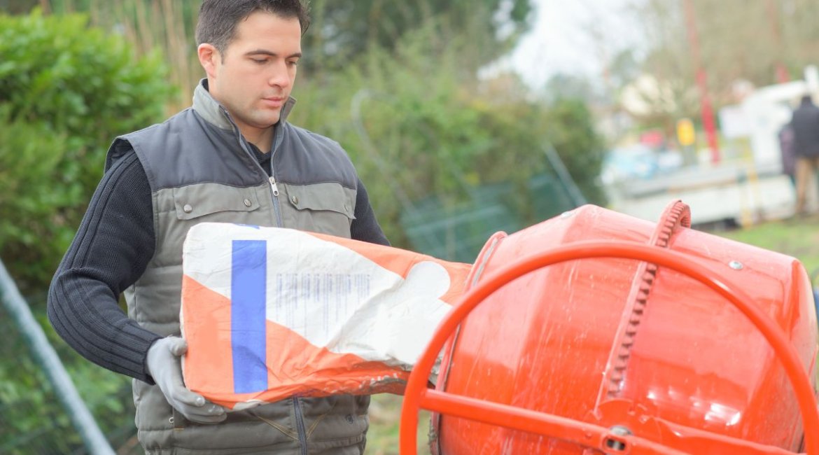 concrete-mixer-for-sale-man-making-cement-with-concrete-machine-min