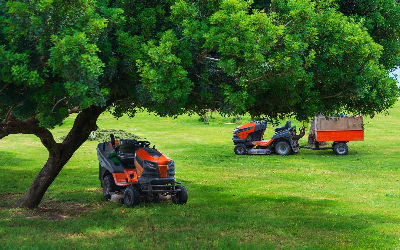 ride-on-mower-lawn-mower-machines-on-green-field-summer-garden-ritual-min