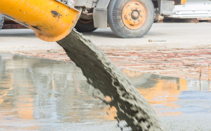 BS Power- concrete mixers - pouring-ready-mixed-concrete-after-placing-steel-reinforcement-to-make-the-road--min