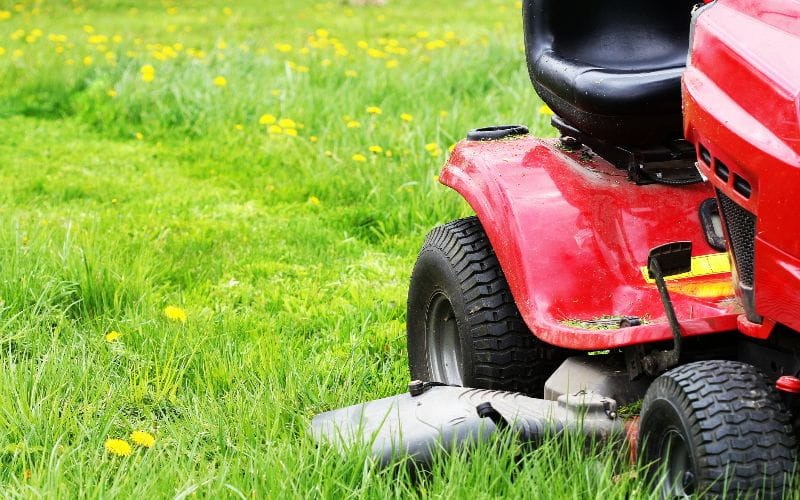 ride-on-mower-gardener-driving-a-riding-lawn-mower-in-a-garden-cutting-grass (1)