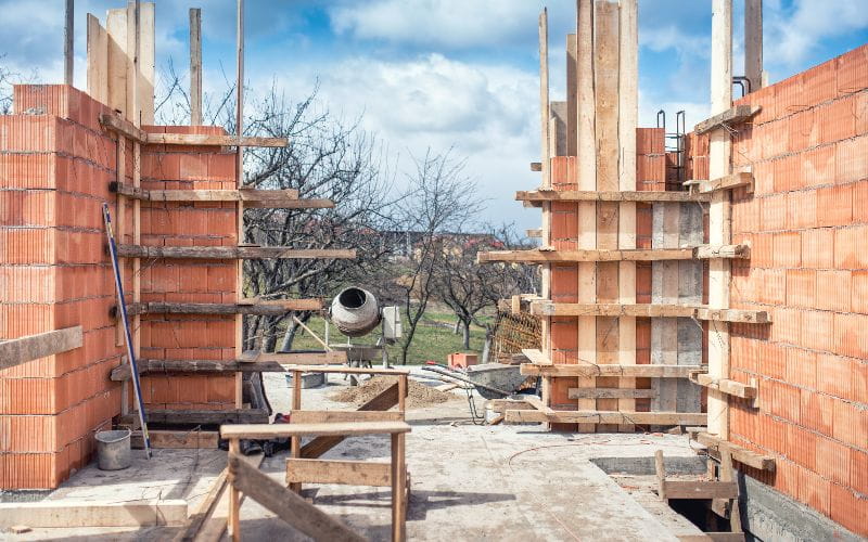 cement-mixers-construction-site-tools-wheel-barrow-sand-and-bricks-at-new-house-building-cement-mixer-machine