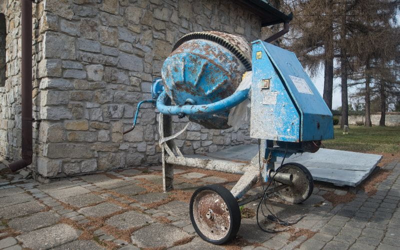 concrete-mixer-an-old-rusty-blue-bent-two-wheeled-electric-concrete-mixer