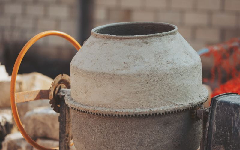 concrete-mixer--dusty-sentinel-of-progress-a-concrete-mixer-stands-idle-at-a-construction-site-its-weathered-exterior-hinting
