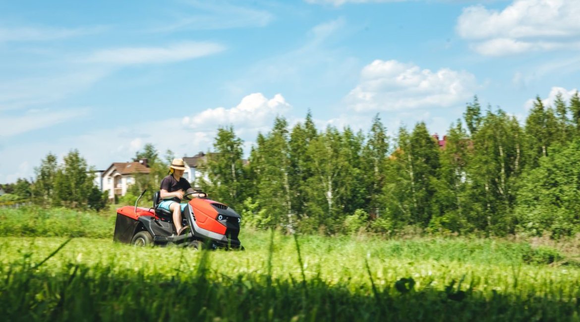 ride-on-mower-man-on-lawn-tractor-mowing-lawn-on-backyard-the-red-rider