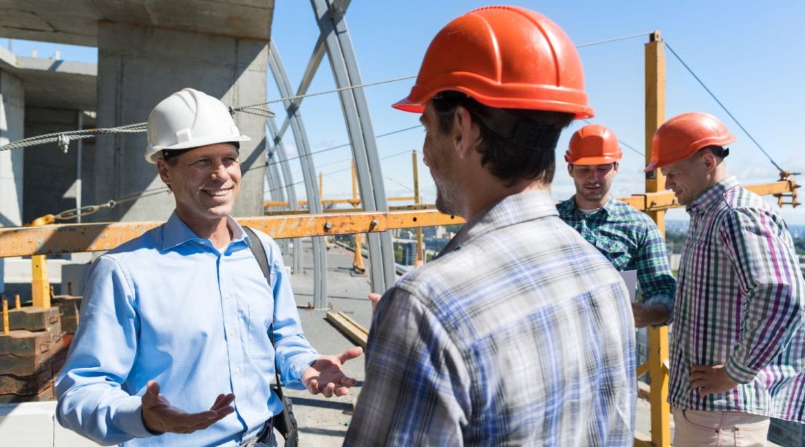 concrete-mixer-for-sale-builders-meeting-on-construction-site-architect-talking-with-contractor-over-group-of-apprentice