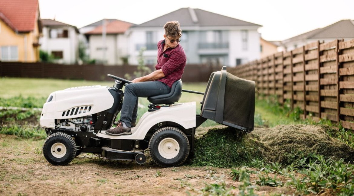 ride-on-mower-gardner-trimming-and-unloading-cut-grass-from-the-garden-using-a-ride-on-lawn-mower (1)