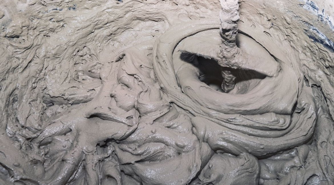 concrete-mixer-industry-background-mixing-tile-adhesive-with-mixer