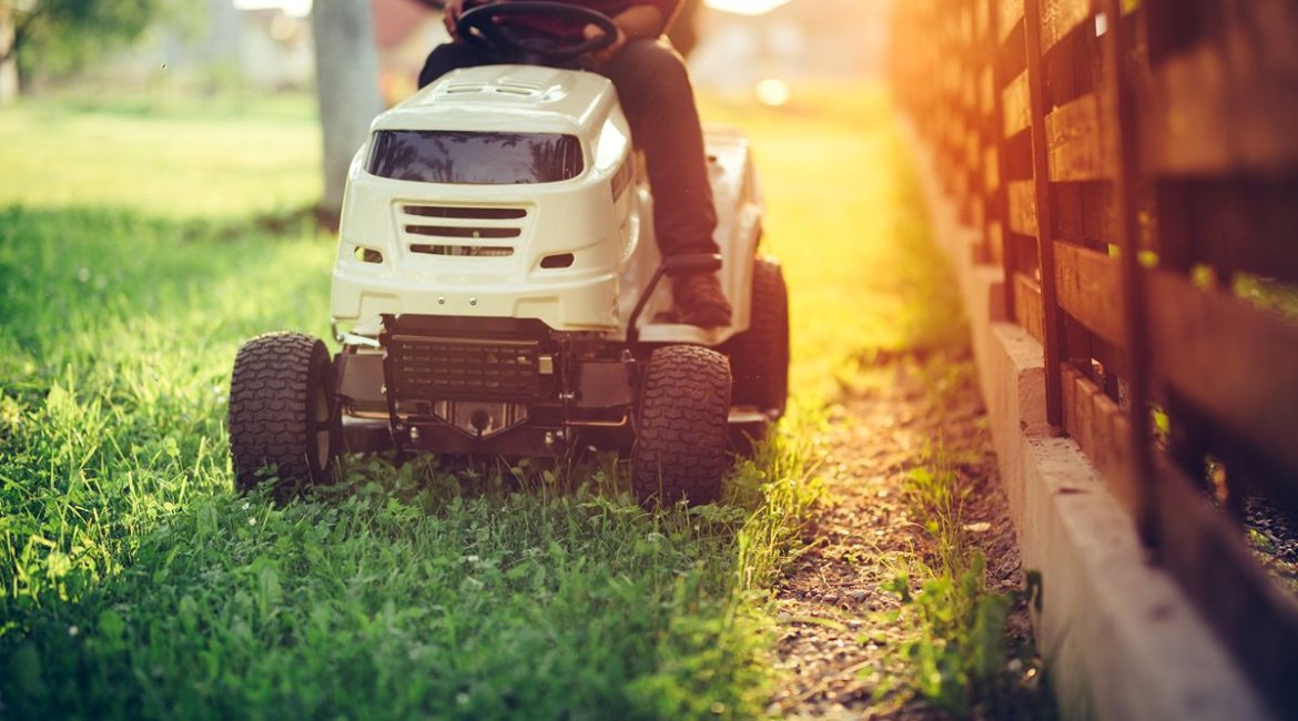 ride-on-mower-details-of-landscaping-and-gardening-worker-riding-industrial-lawnmower