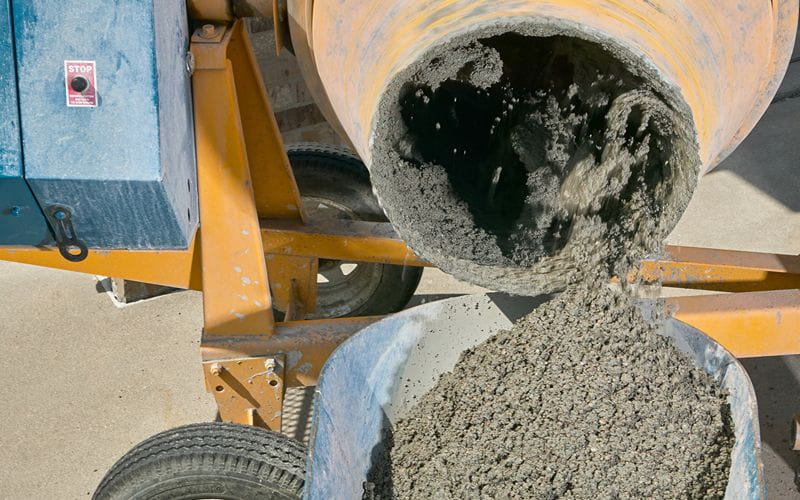 concrete-mixer-pouring-wet-cement-into-wheelbarrow (1)