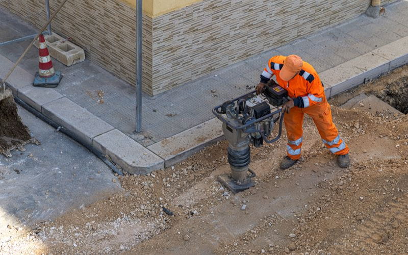 rammers- construction-worker-in-orange-safety-gear-operating-a-tamping-rammer-machine (1)