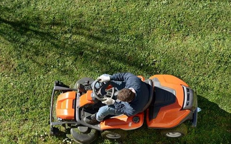 ride-on-mower-man-mowing-lawn-orange-mower (1)